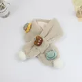 Detailed view of plush beige scarf with cute cartoon embroidery and soft white pom-poms - 75*10cm / Khaki