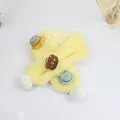 Close-up of plush yellow children's scarf with cartoon patches and white pom-poms - 75*10cm / Light Yellow