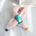 Detail of pink plush scarf for kids with green dinosaur patch and colorful pom-poms - Crocodile Style (Pink Variant)