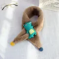 Detail of plush brown children scarf with green crocodile patch and colorful pom-poms - Crocodile Style (Khaki Variant)