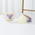 Detail view of straw sun visor hat and matching round crossbody bag with purple bow - 48-52cm / Single Hat / Creamy White - Purple Rabbit