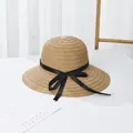 Women's woven straw sun hat with wide brim and black silk bow ribbon on white surface - Black Bow / Khaki