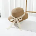 Detail of straw sun hat featuring elegant cream lace ribbon and a delicate bow tie - S Kids Size / Khaki