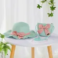 Detailed texture of mint green straw hat and matching bag with pink bow decorations - S Kids Size / Lotus Leaf Hat and Bag Set / Green