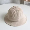 Close-up of beige corduroy kids bucket hat showing ribbed texture and fine stitching - Beige