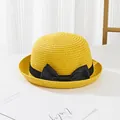 Detailed texture of yellow straw sun hat with elegant black ribbon bow accessory - Kids / Yellow
