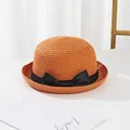 Detailed view of children straw sun hat featuring orange weave and black ribbon bow - Kids / Orange