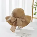 Macro view of woven straw sun hat featuring elegant wavy brim and oversized bow detail - M (Adult) / Wave Edge Style / Wavy Edge Khaki