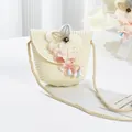 Detailed view of child's straw crossbody bag with floral accents and woven strap - Lily of the Valley Bead Flower / 15*13cm / Cream