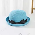 Close-up of sky blue woven straw hat with elegant black bow ribbon and fine texture - Sky Blue
