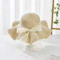 Detailed view of straw hat texture with elegant white lace ribbon bow and wavy brim - S Kids / Water Grass Flower Bow Ribbon (Ruffled Edge) / Beige