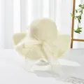 Detailed view of cream straw hat with wide wavy brim and elegant lace bow decoration - S Kids / Water Grass Flower Bow Ribbon (Ruffled Edge) / Cream