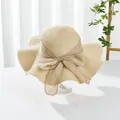 Close-up of beige woven straw hat with a large bow detail and elegant texture - M (Adult) / Wave Edge Style / Wavy Edge Beige
