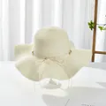 Elegant wide brim straw sun hat with pearl bow detail for summer beach vacations - M / Cream