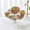 Close-up of sun straw hat with wavy brim and white lace bow on a minimalist desk - S Kids / Grid Bow Ribbon (Ruffled Edge) / Khaki