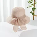 Detail of light pink woven sun hat featuring a large mesh bow and textured spiral weave - M (Adult) / Large Brim Style / Large Brim Pink