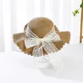 Brown woven straw beach hat with white lace bow decoration and wavy brim - S Kids / Water Grass Flower Bow Ribbon (Ruffled Edge) / Khaki