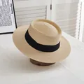 Detail of a beige flat-top straw hat with a wide black ribbon and fine woven texture - M Adult (56-58cm) / Beige with Black Border