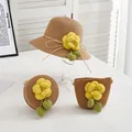 Detail of straw hat and woven bags set featuring yellow fabric flowers and green leaves - Kids Hat / Khaki - Yellow Camellia