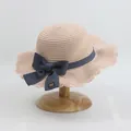 Pink straw sun hat for girls featuring a navy blue ribbon bow and wavy brim design - S Kids Size / Lotus Leaf Single Hat / Pink