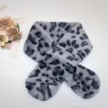 Detail of grey leopard print plush scarf with cross-over design and faux fur texture - Gray Leopard Print