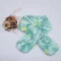 Detail view of tie-dye plush kids scarf with mint green faux fur and silk flower accent - Green Tie-Dye