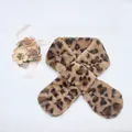 Detail of plush faux fur leopard print scarf featuring a crisscross fastening design - Leopard-Khaki