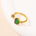 Detailed view of adjustable gold ring with green cat eye stone and floral gold accents - Gold Green Cat Eye Stone