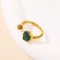 Detail of adjustable gold ring featuring an oval green cat-eye stone and beaded texture - Gold Dark Green Cat's Eye