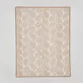 Tan Nordic knitted blanket with white leaf jacquard texture in a minimalist aesthetic - Khaki