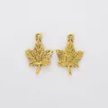Close-up of golden maple leaf pendants with detailed veins and top hanging holes - Antique Gold