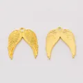 Pair of vintage gold zinc alloy angel wing pendants with detailed feather texture - Gold