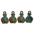 Macro shot of antique bronze money bag charms with turquoise patina and dollar sign symbol - Antique Green