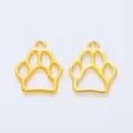 Close-up of golden hollow paw-print pendants for DIY jewelry and necklaces - Gold
