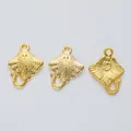 Detailed view of three golden devil ray alloy charms with textured metal surfaces - Gold