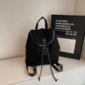 Minimalist black backpack in matte suede and glossy leather finish with gold hardware - Black