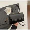 Minimalist black PU leather crossbody bag with curved flap and gold hardware accents - Black