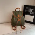 Retro dark green suede backpack with brown leather straps on white marble - Green