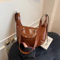 Vintage brown hobo bag with round metal rivets in a retro crescent half-moon style - Brown