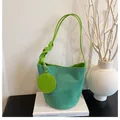 Detail of green suede bucket bag featuring braided strap and matching round coin purse - Green