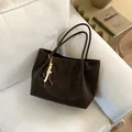 Deep brown faux suede leopard print tote bag with beaded tassel on a white sofa - With Pendant / Coffee