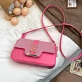 Pink leather saddle bag with woven pattern and gold geometric lock in variant view - Pink