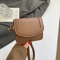Brown textured leather crossbody bag with elegant gold hardware and U-shaped stitching - No Pendant / Brown