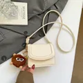 Chic beige underarm bag with lychee texture and cute furry monster charm accessory - With Pendant / White