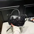 Chic black plush faux shearling handbag with adjustable shoulder strap and leather trim - Black