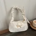 Borsa a spalla color crema con fiocco dorato e tracolla arricciata su vetro - Bianco