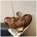 Brown leather tote bag with knot detail and wide shoulder strap in minimalist style - Brown