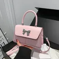 Pink and purple sequined crossbody bag with silver bow accent and adjustable strap - Pink