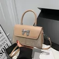 Elegant apricot bow handbag with champagne rhinestones and silver metallic detail - Khaki