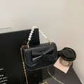 Mini schwarze Umhängetasche mit Schleife, Perlengriff und goldener Kette - Schwarz
